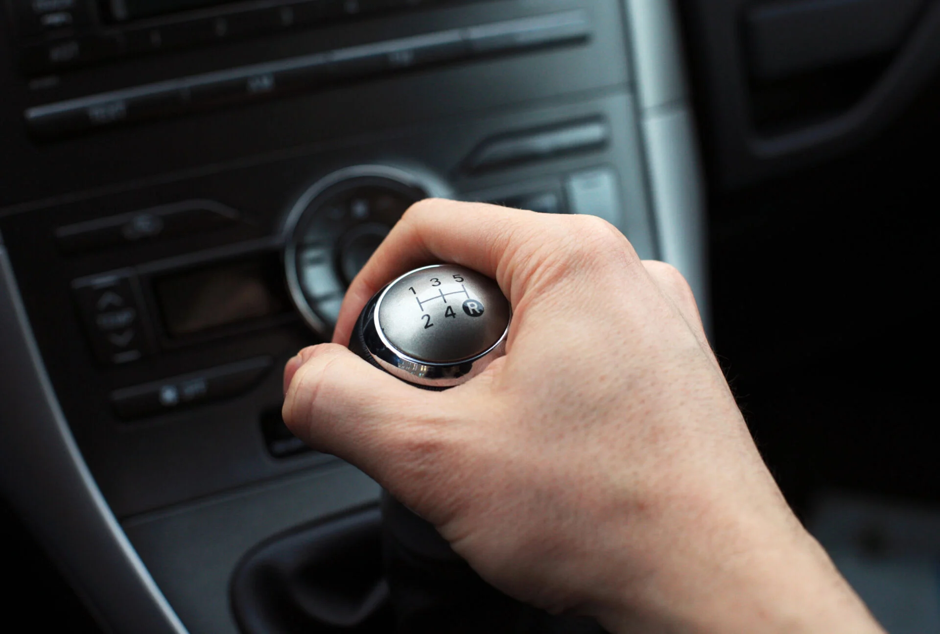 Hand on manual gear shift knob.