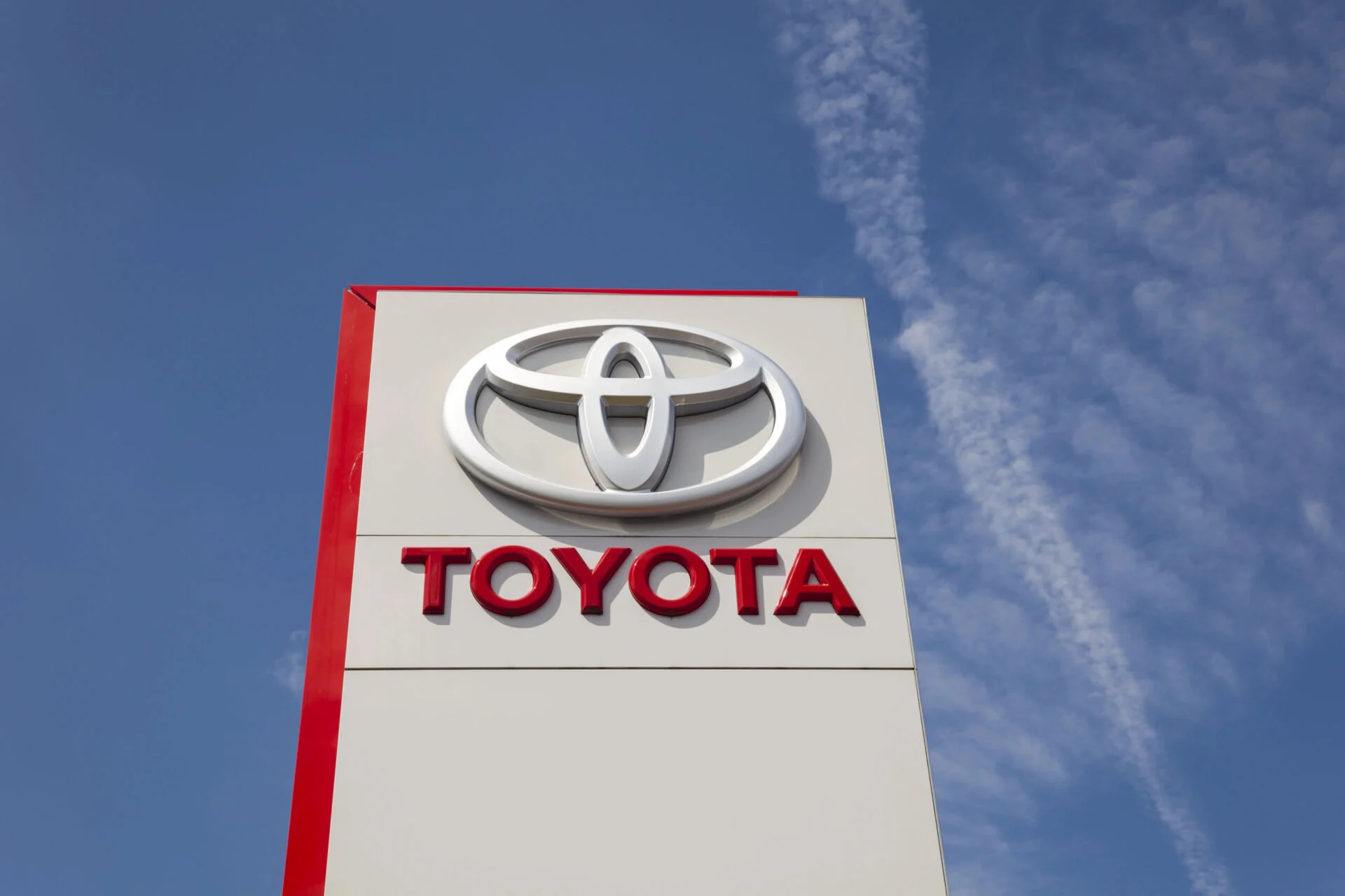 Toyota dealership sign with blue sky behind it