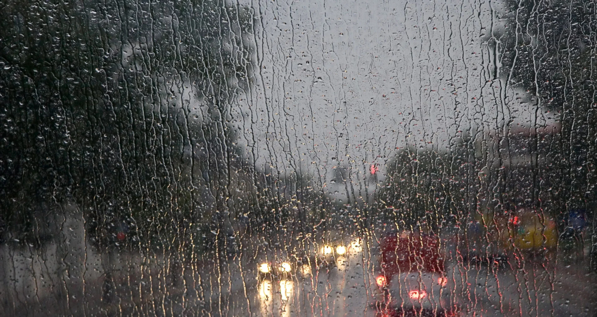 Car window with obstructed view due to rain