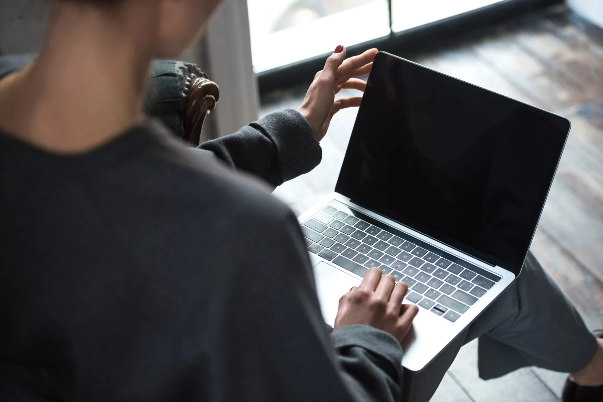 Person sitting down and working on a laptop computer