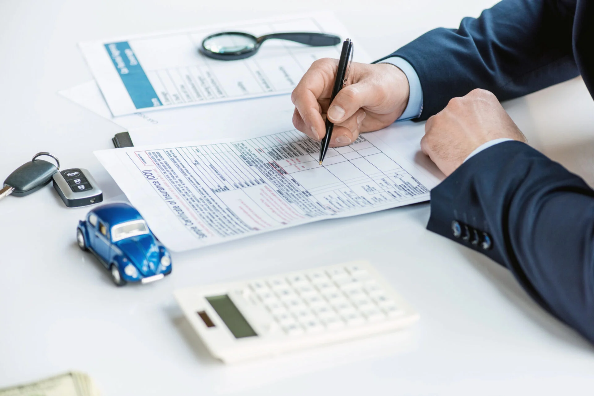 Man signing insurance document on table