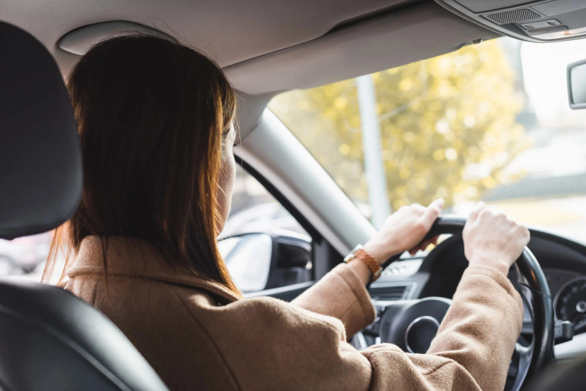 back view of a woman driving a car