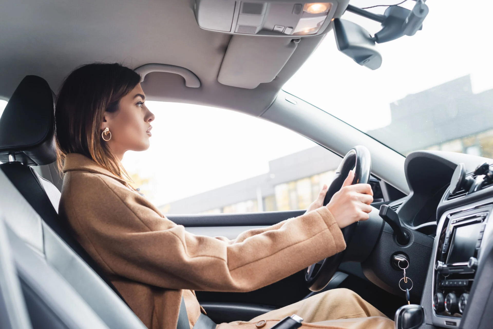 Woman driving a vehicle with black interior
