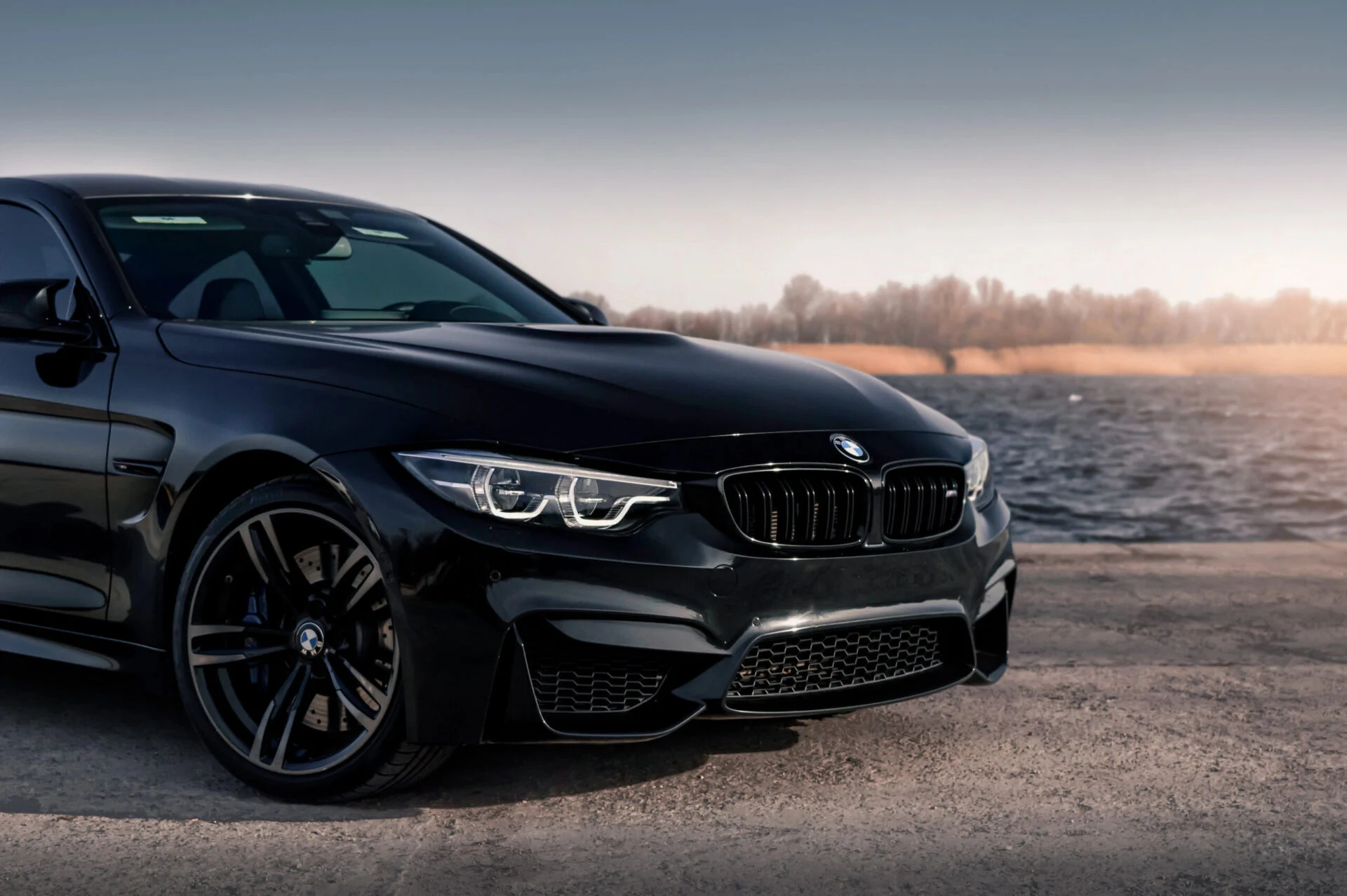 Black BMW M4 at sunset