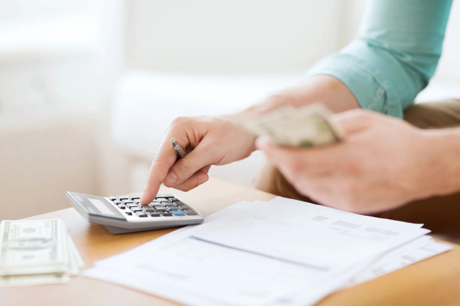 Woman counting cash and calculating