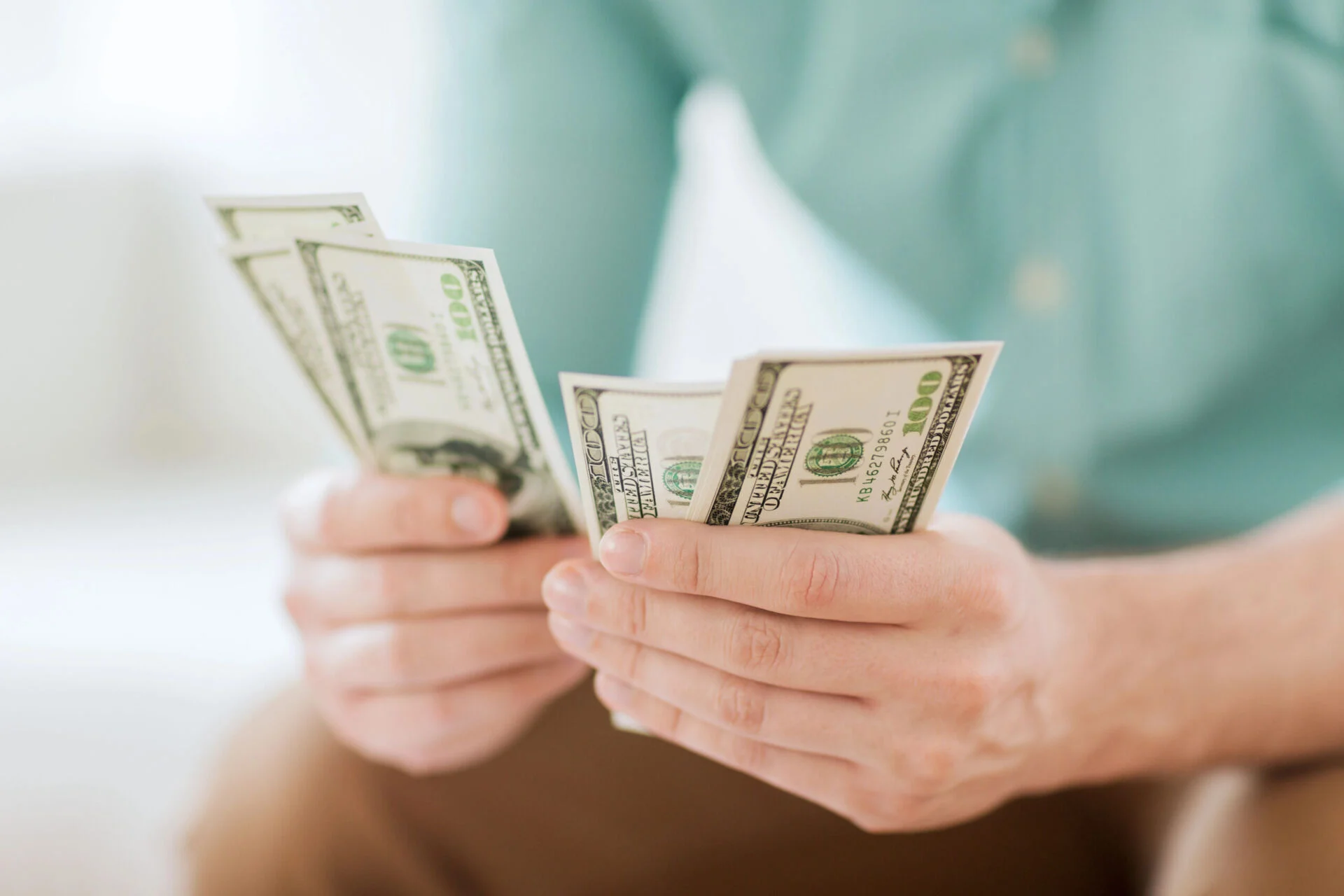 Man sitting down counting cash