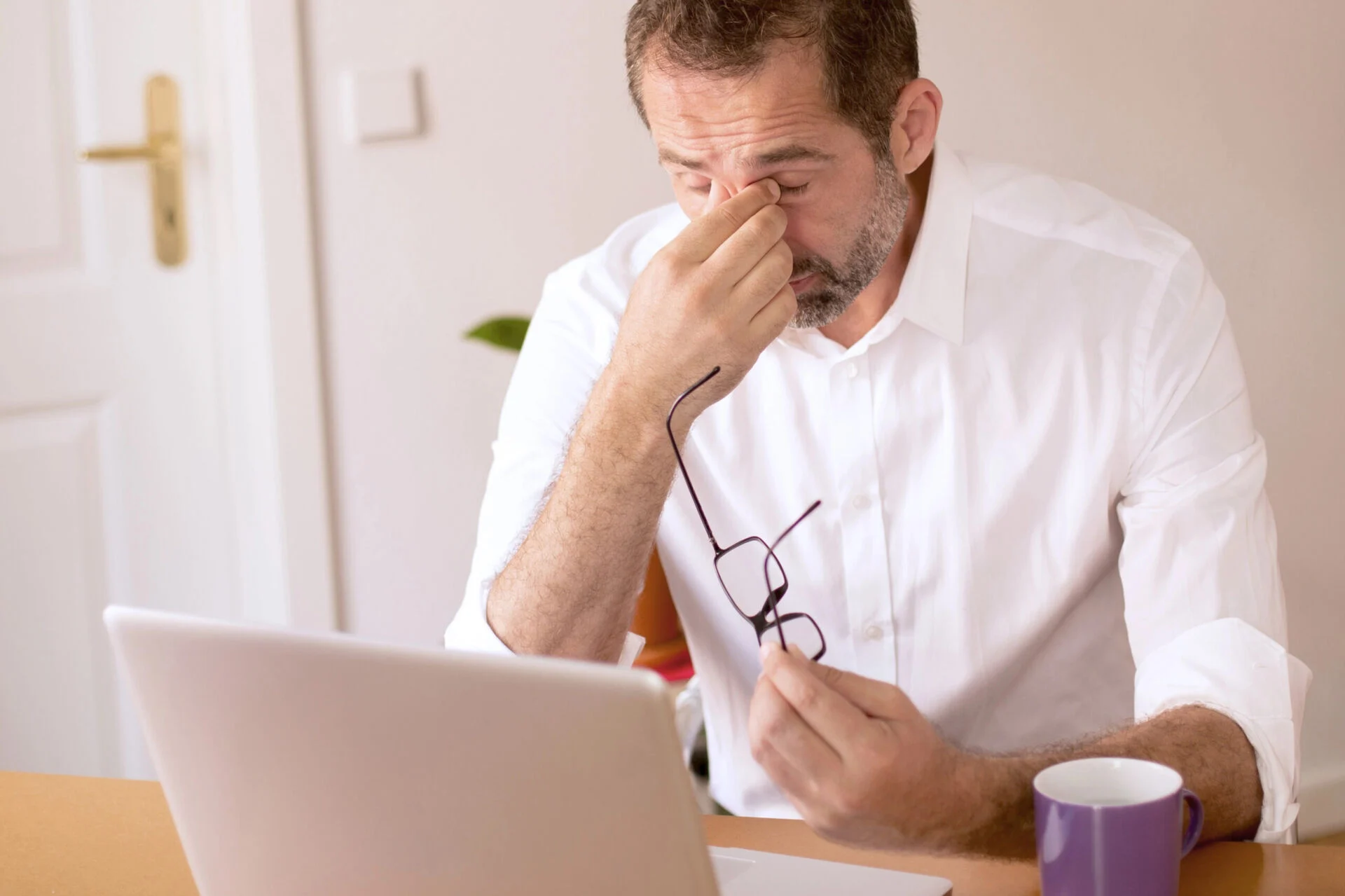 Man frustrated in front of laptop