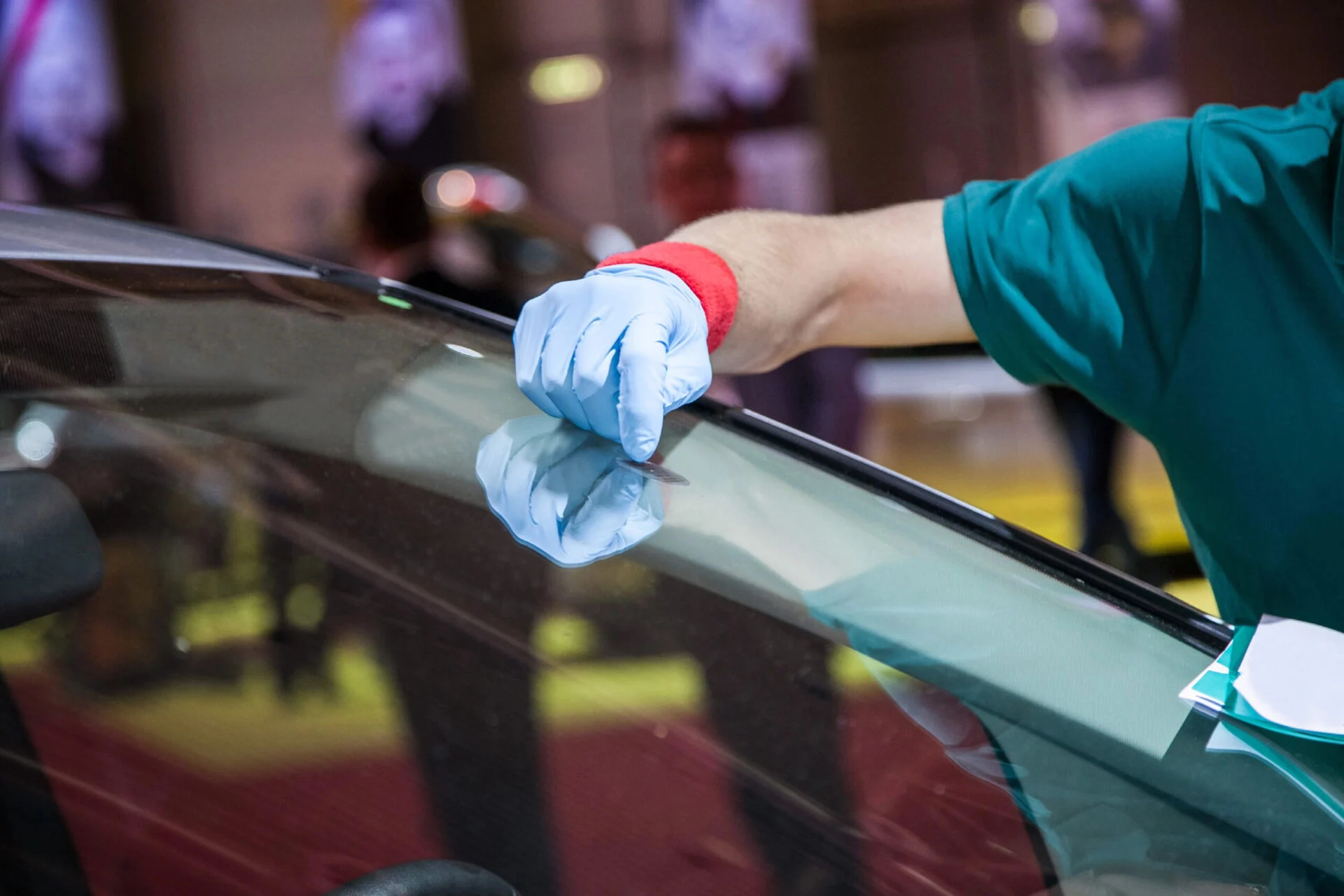 Close up of someone inspecting a car windshield