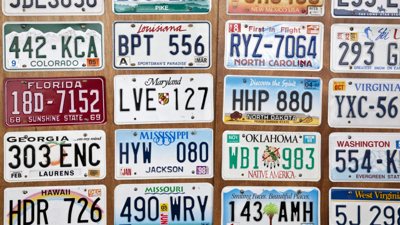 License plates from various states hang on a wall
