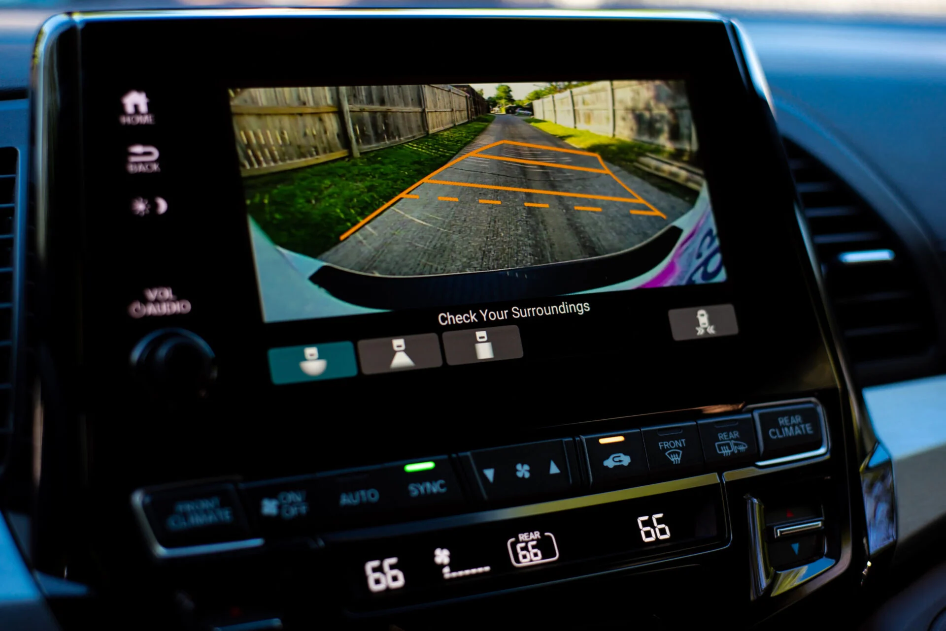 Media screen inside of car displaying reverse camera
