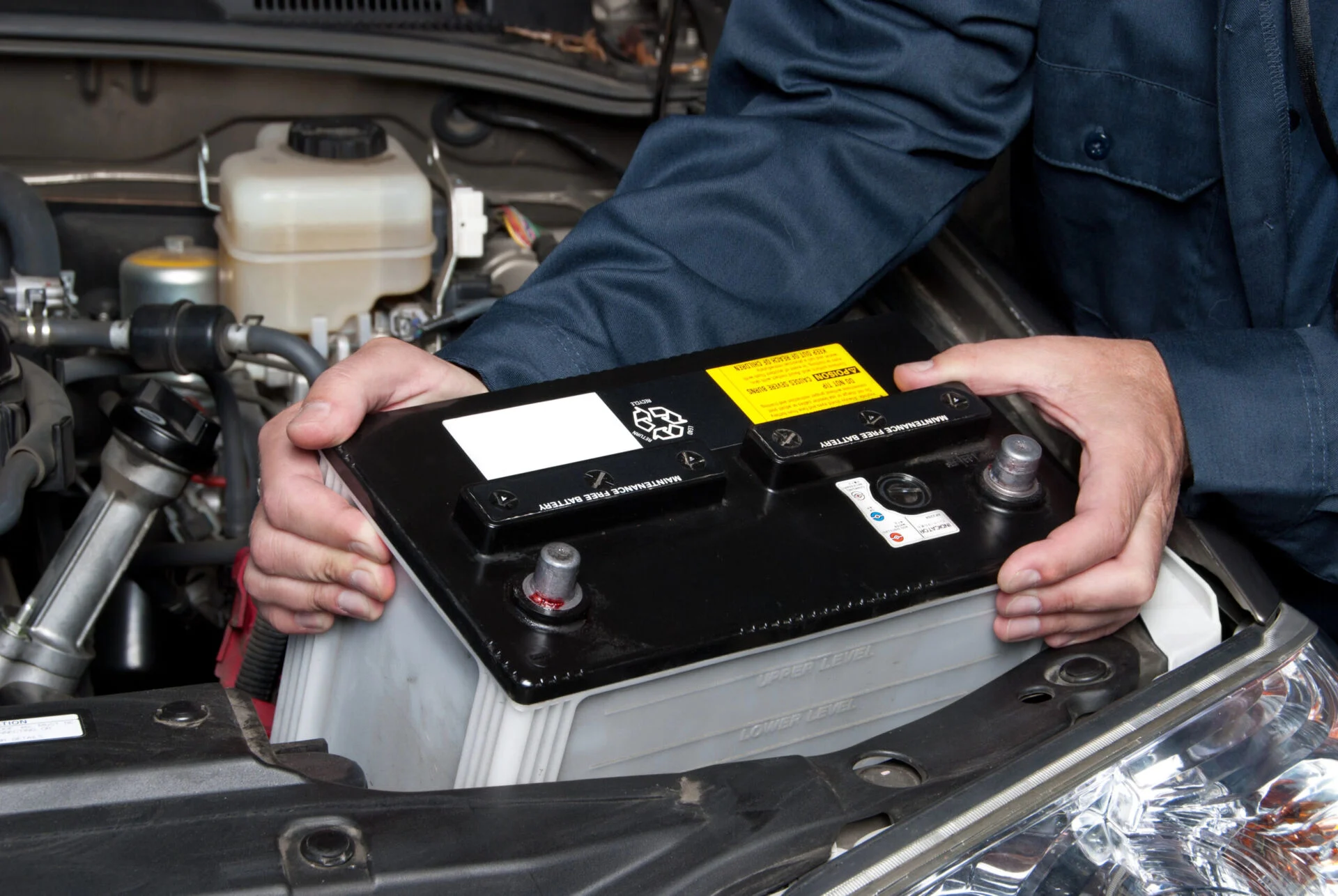 Person holding a car battery