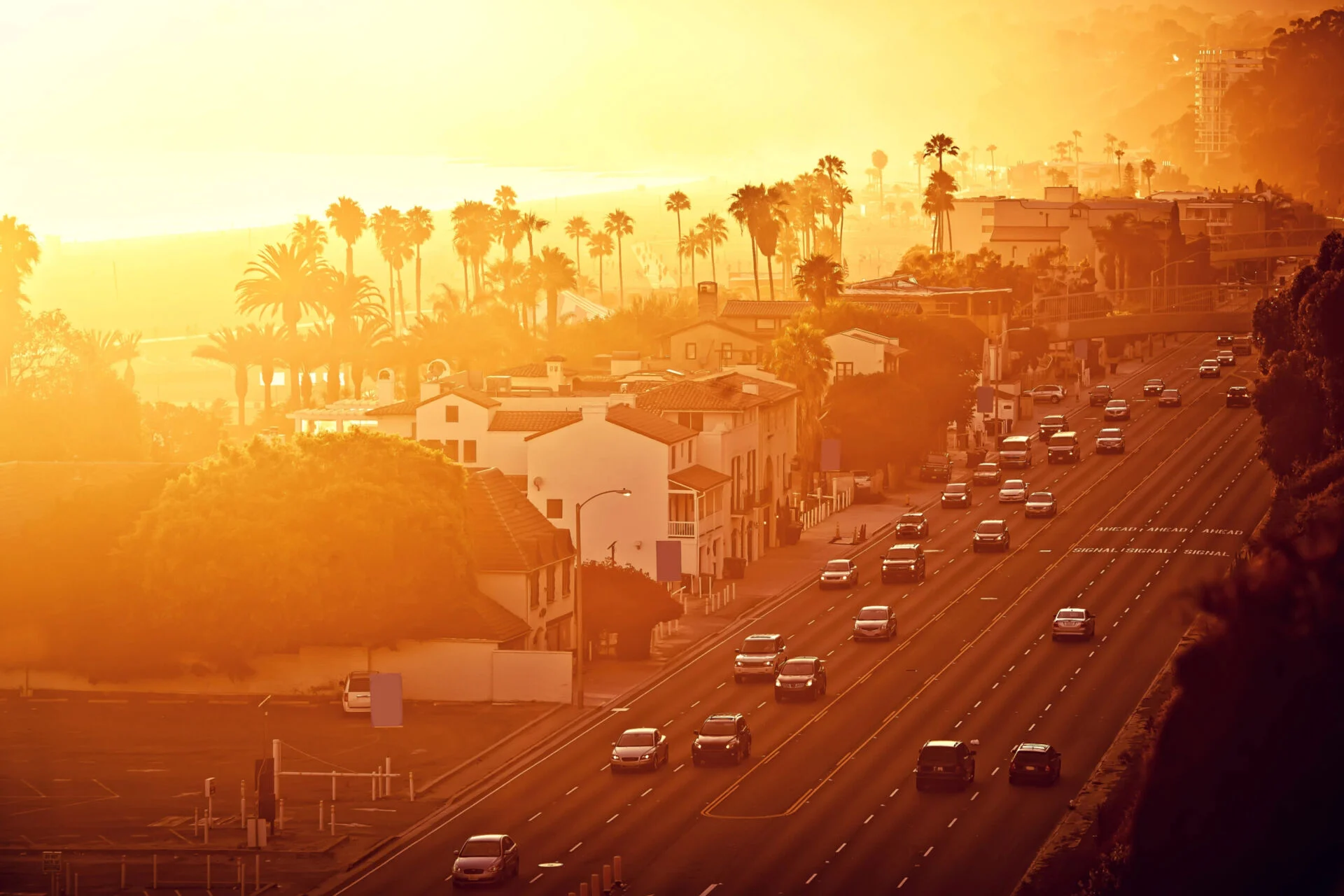 California sunset while cars drive along a road
