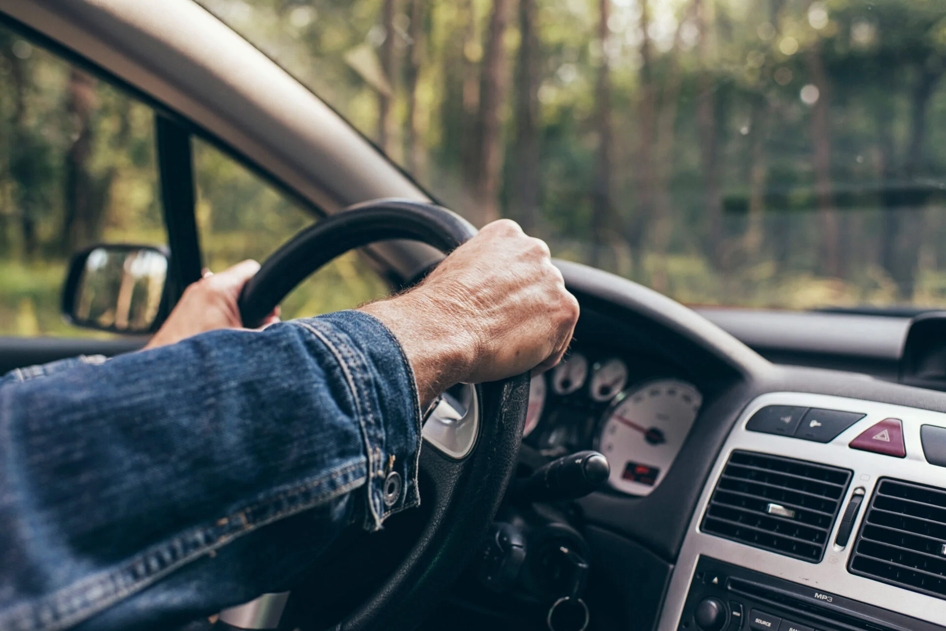 Person with hands on steering wheel